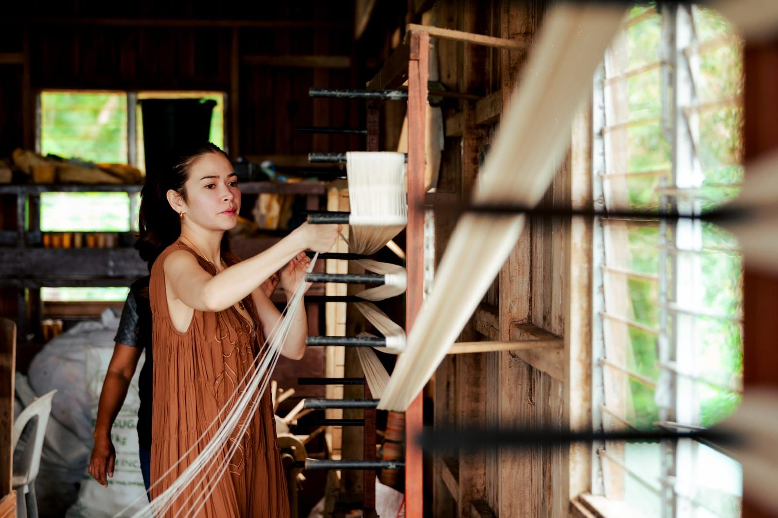 Bela Padilla at the warping frame by the window
