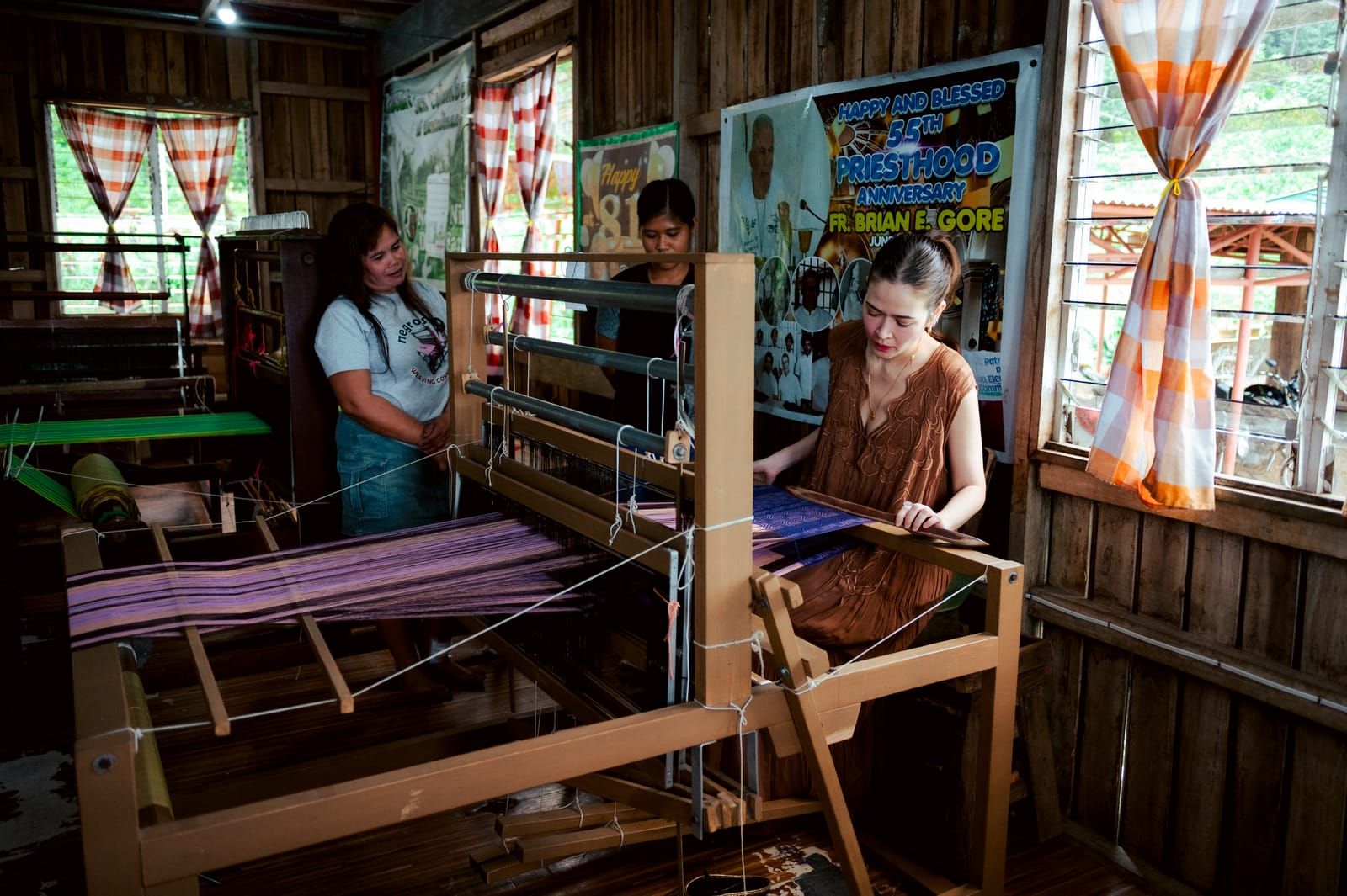 Bela Padilla at a loom inside the weaving centre