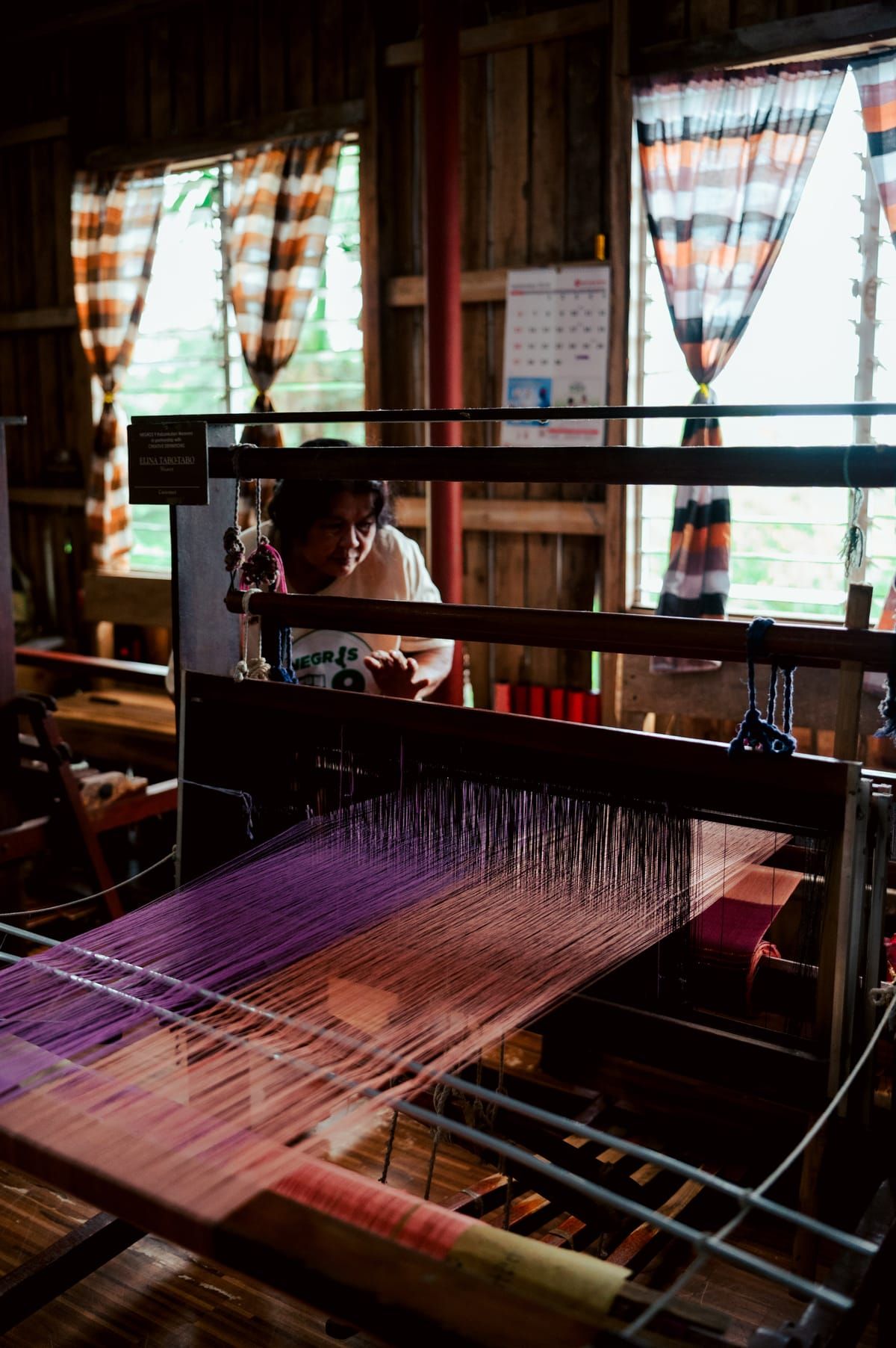 A weaver at work at her loom