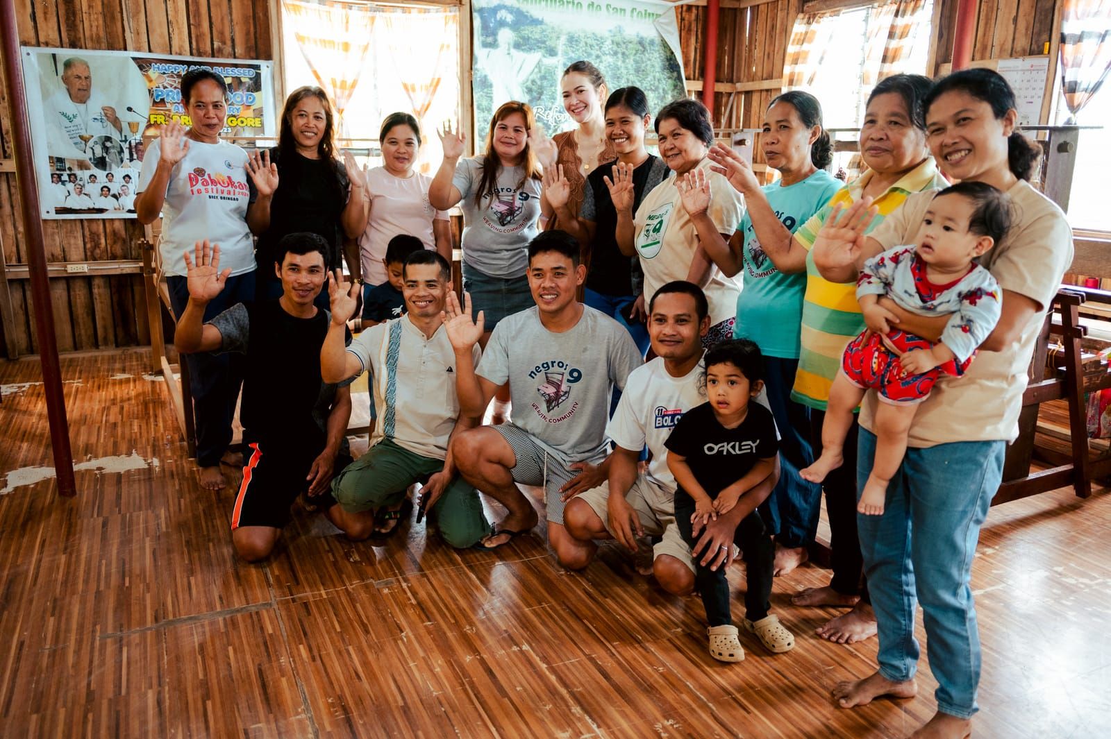 The Negros Nine Weavers and their families waving