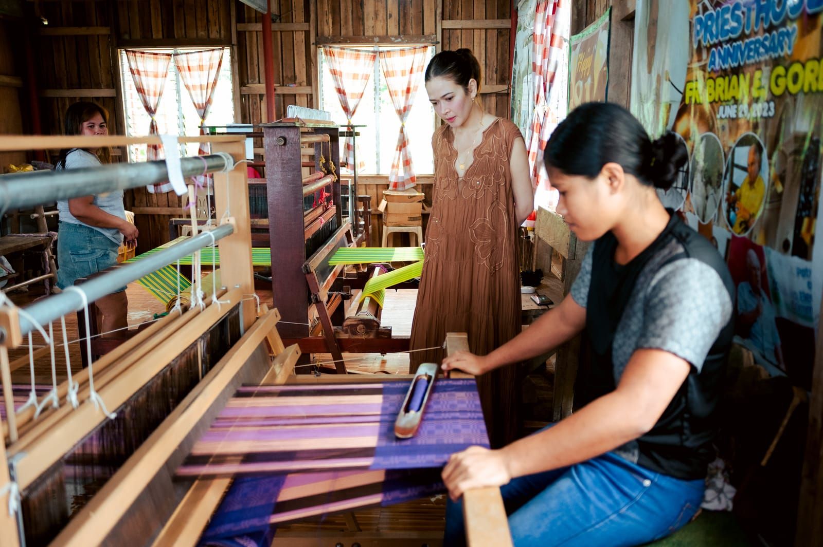A Negros Nine weaver at her loom while Bela Padilla watches