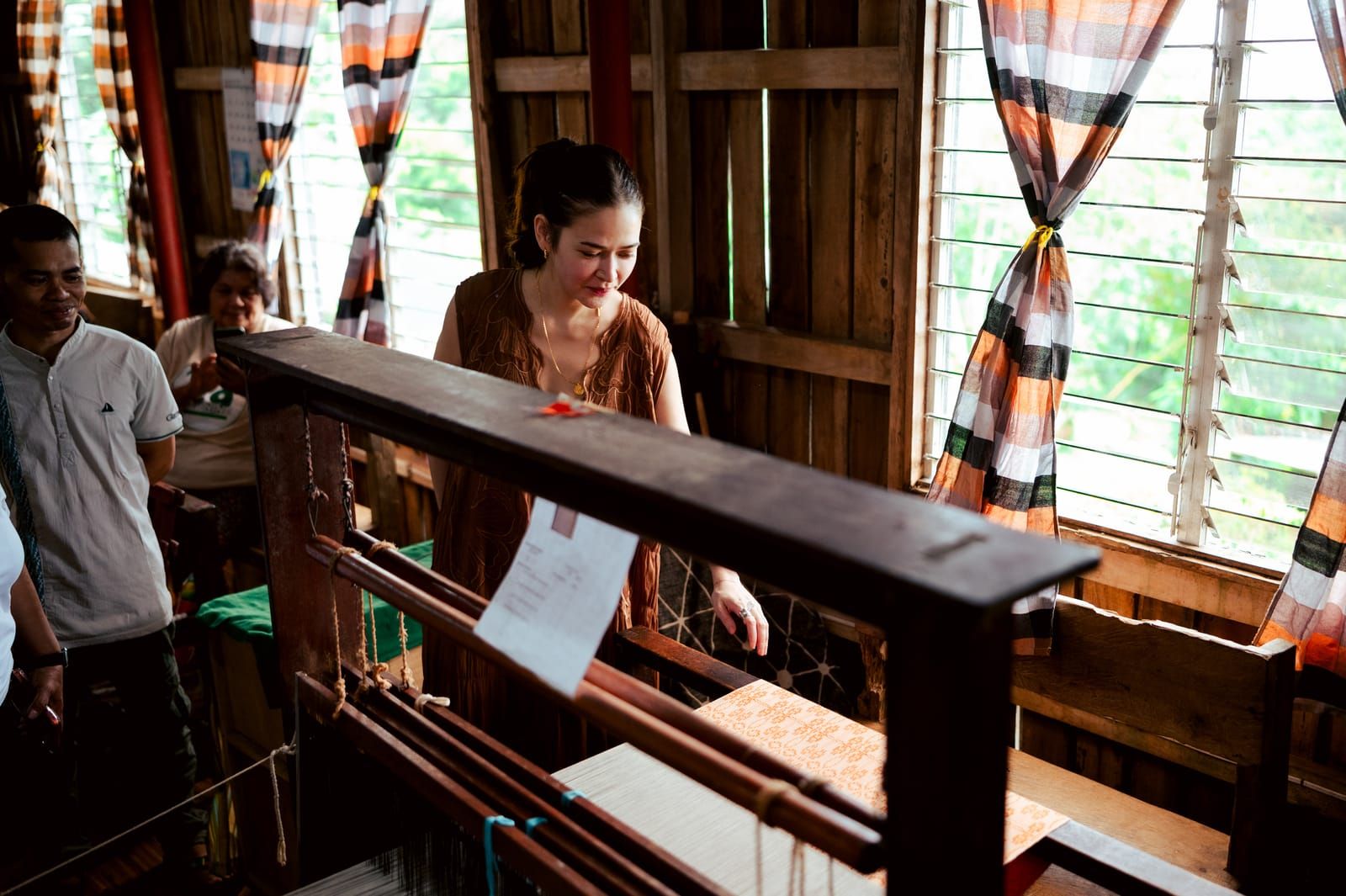 Bela Padilla at a loom with the weavers