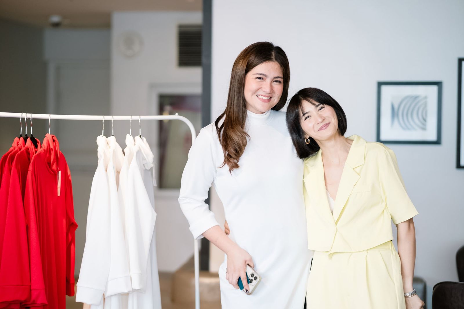 Dimples Romana in white with a guest beside the collection's rails