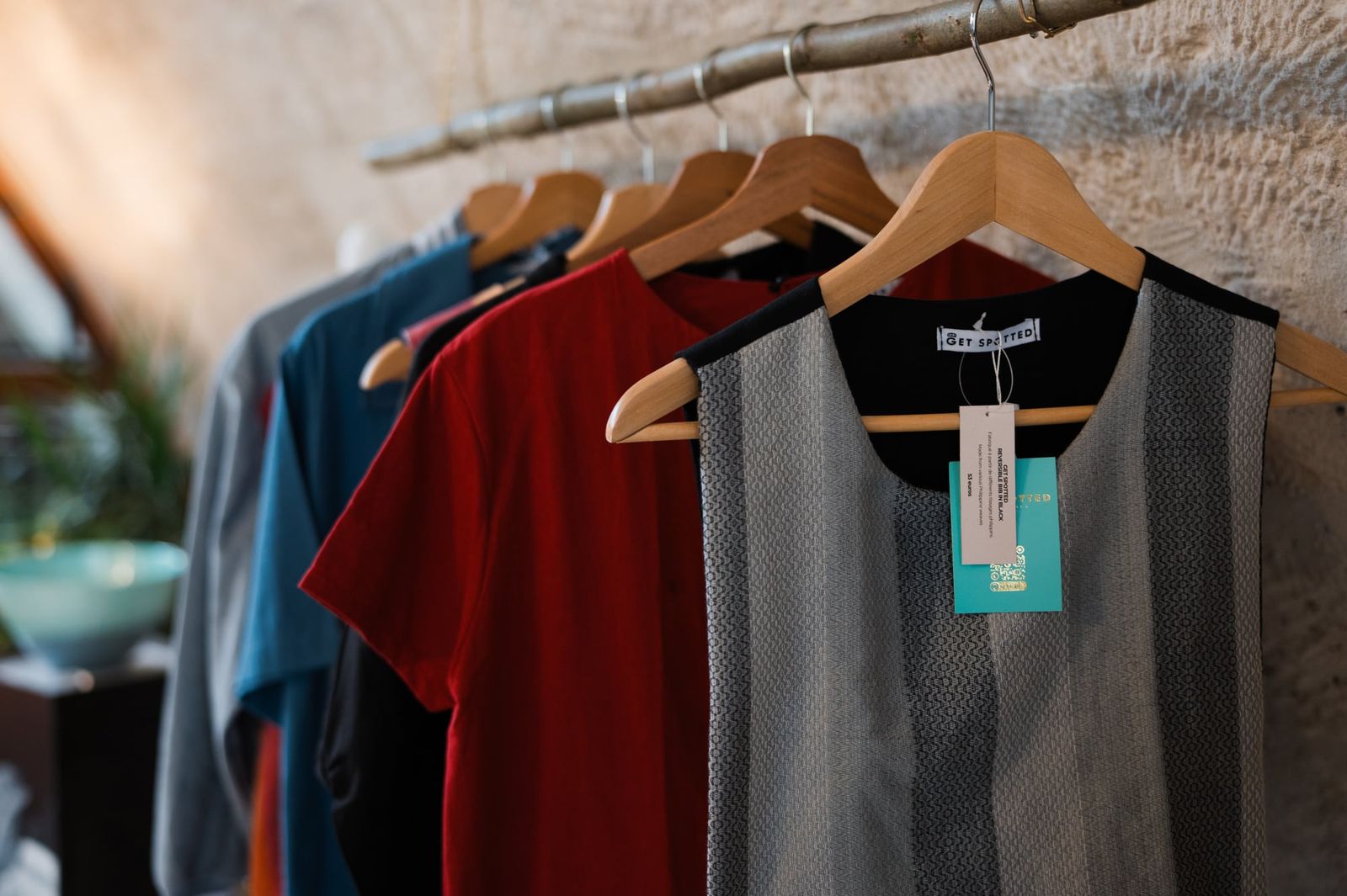 Close-up of handwoven hablon tops and vests from CHICKS x Get Spotted on hangers