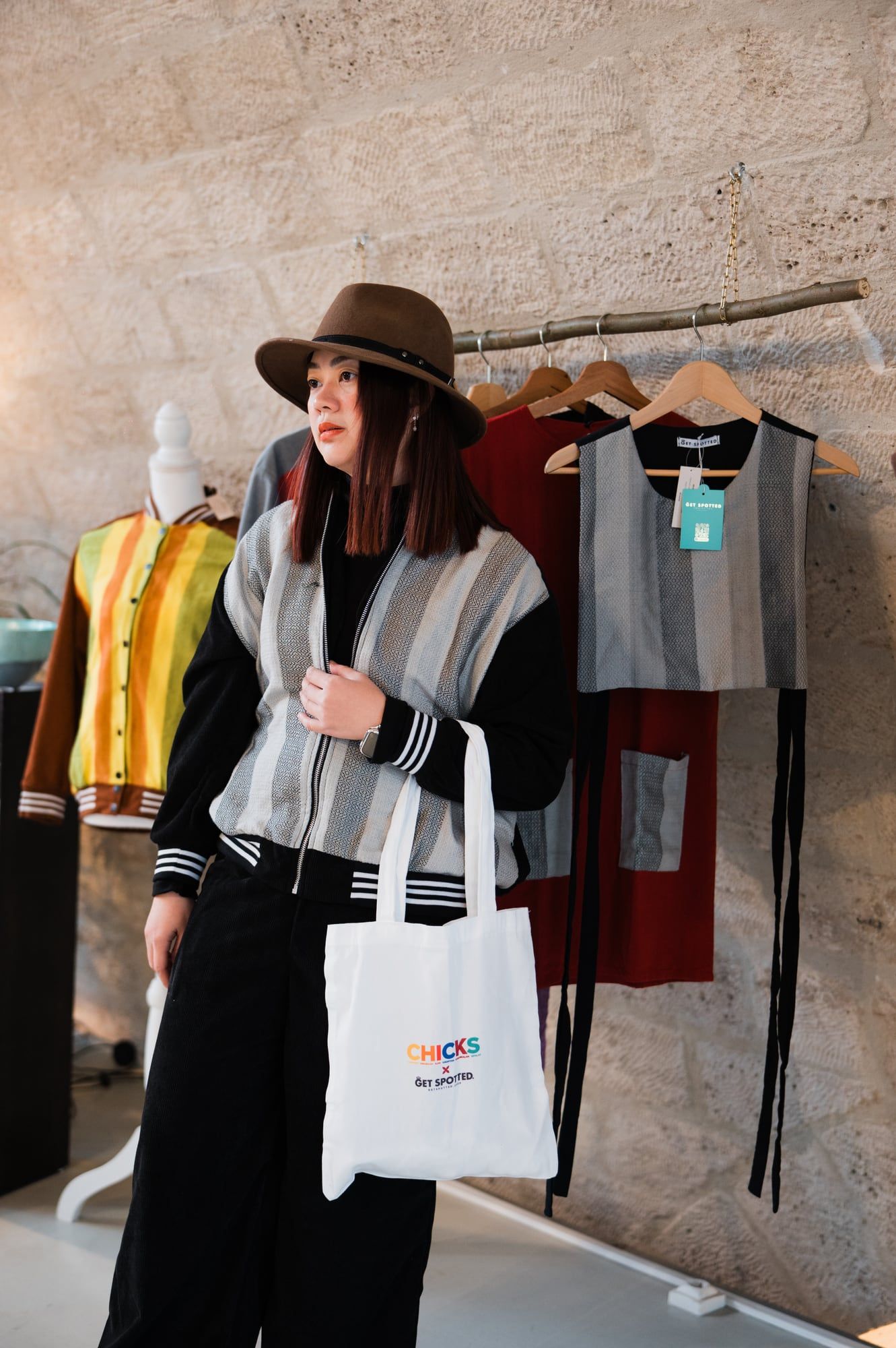 Emgee wearing the CHICKS x Get Spotted bomber jacket in Paris, with a CHICKS tote