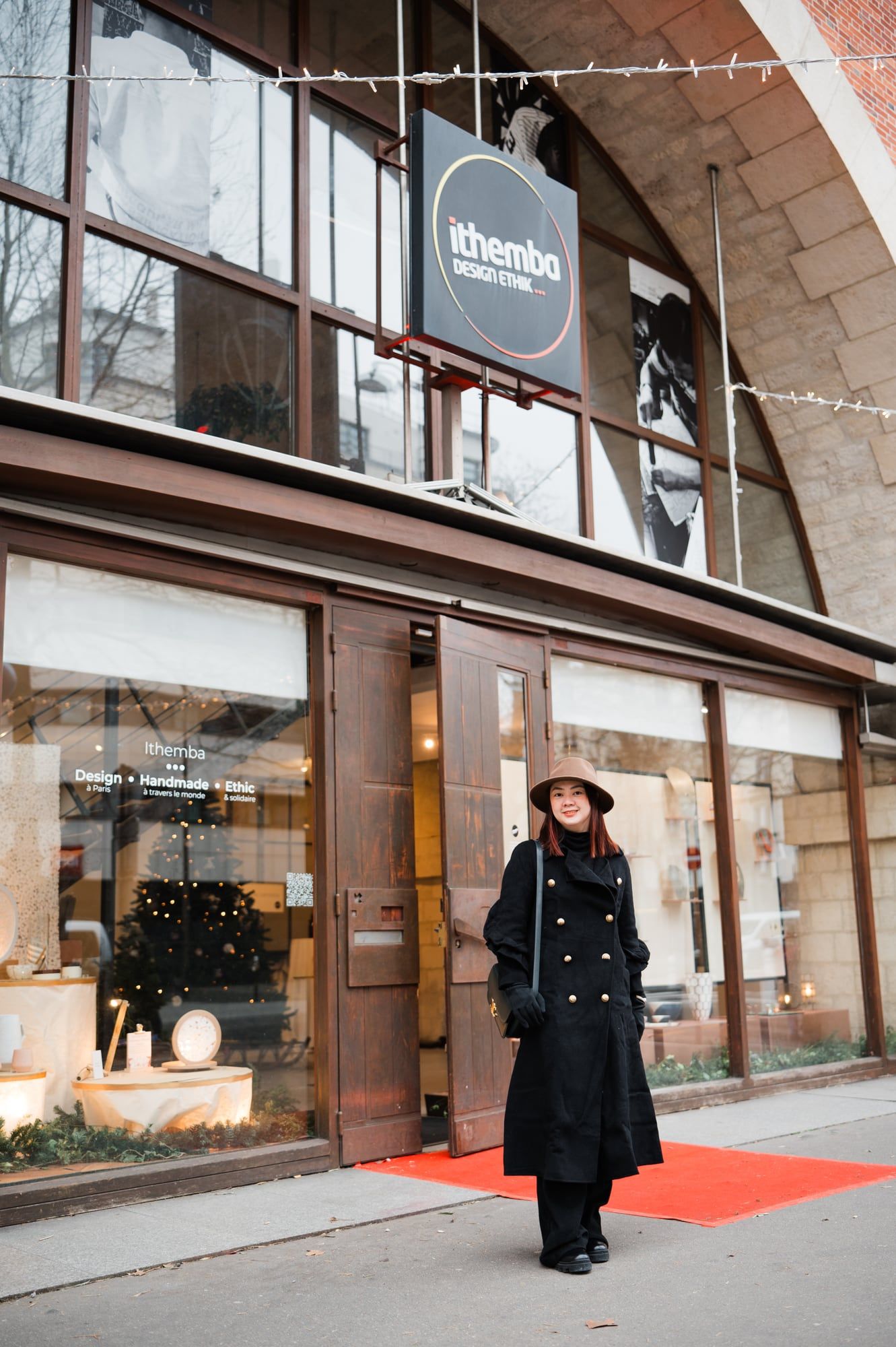 Emgee in front of the Ithemba showroom's arched shopfront, Paris 12