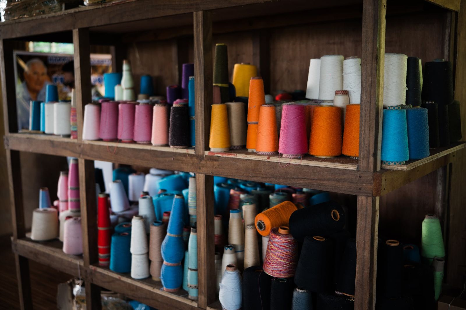Shelves of cotton thread cones in every colour at the Negros 9 weaving centre