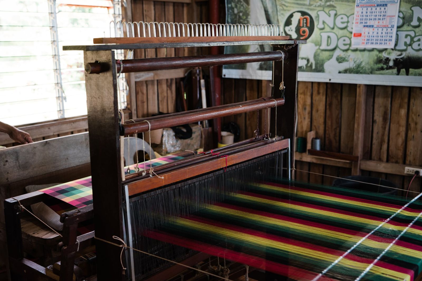 A wooden handloom at the Negros Nine Weavers centre in Kabankalan, with a striped fabric in progress