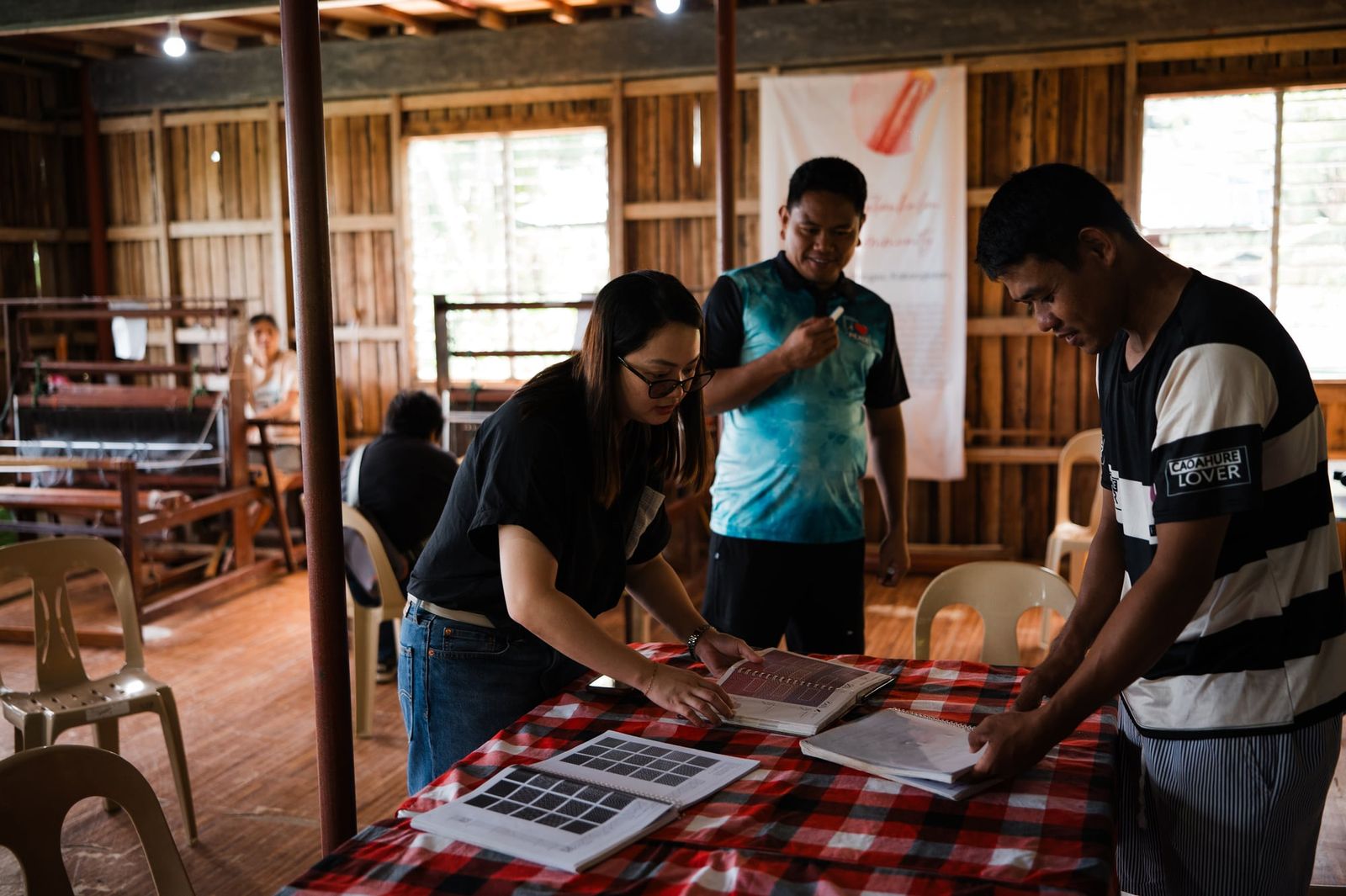 Going over fabric swatches and designs together with the weavers