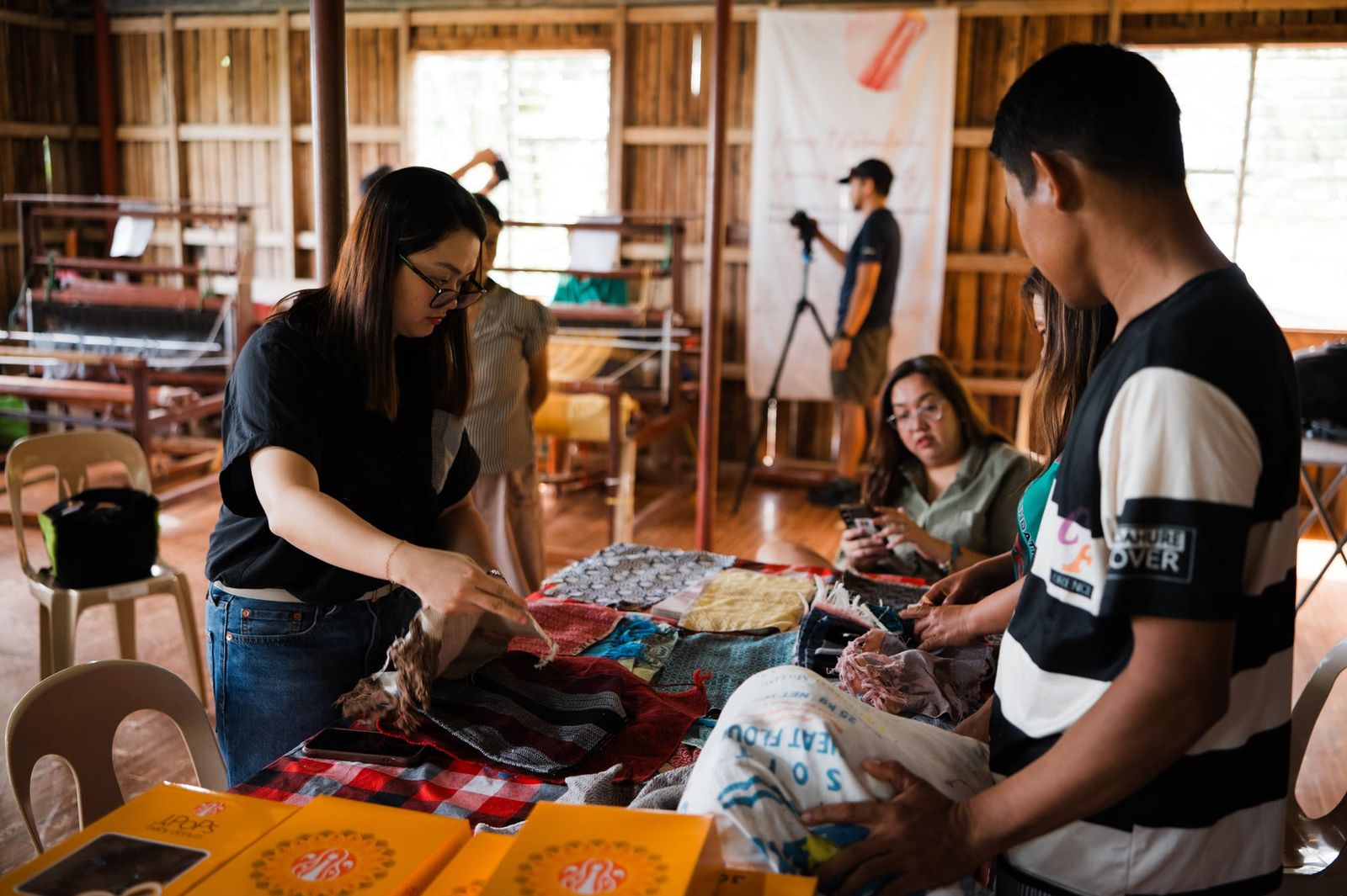 Looking through handwoven fabrics together at the weaving centre