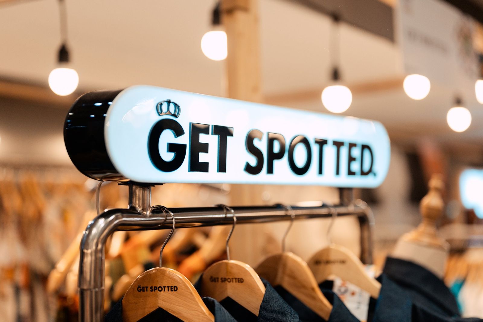 The lit GET SPOTTED sign over our rack at Himbon, the Negros Trade Fair 2025