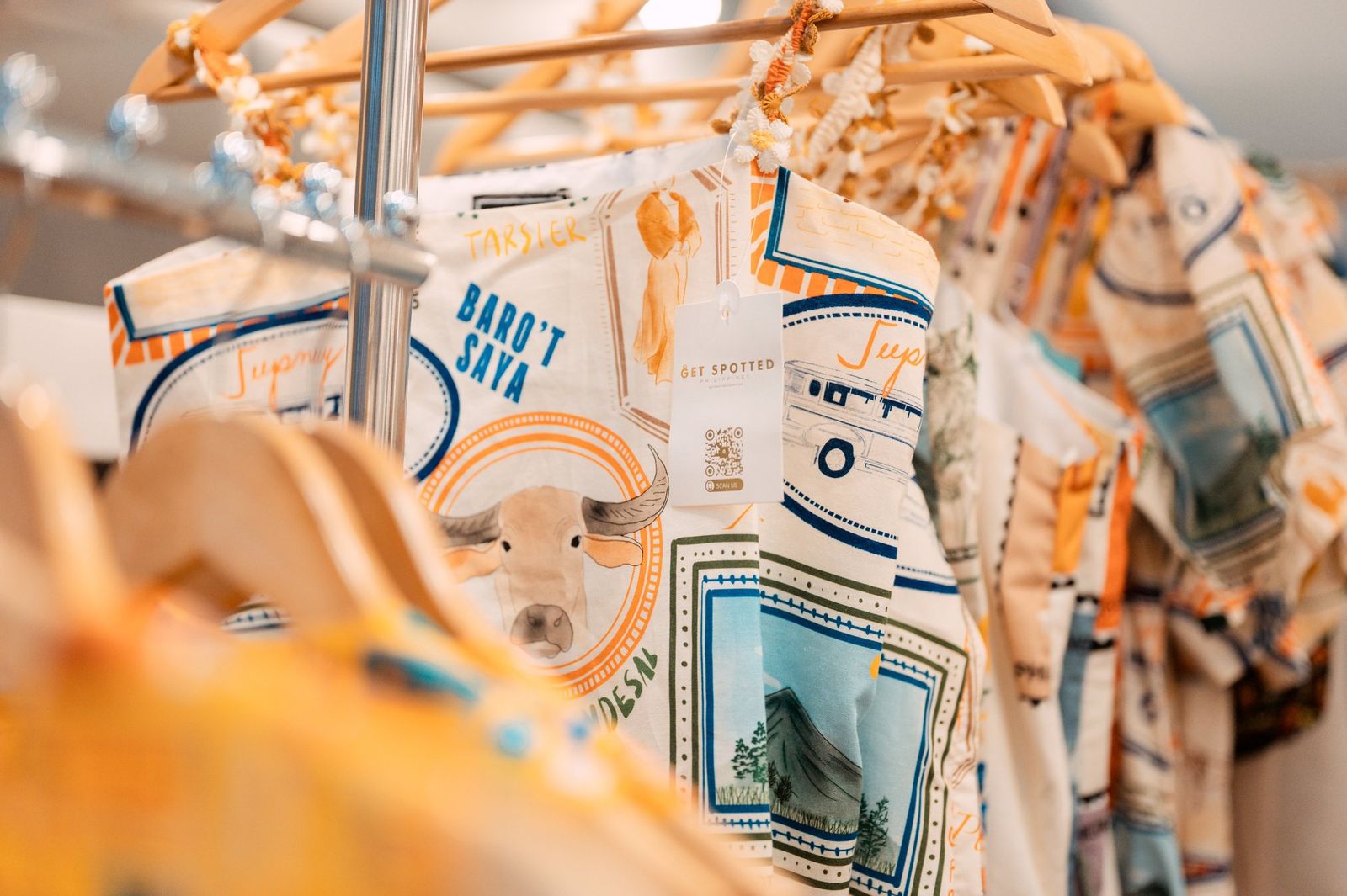 Filipino print shirts on wooden hangers at our Negros Trade Fair 2025 booth