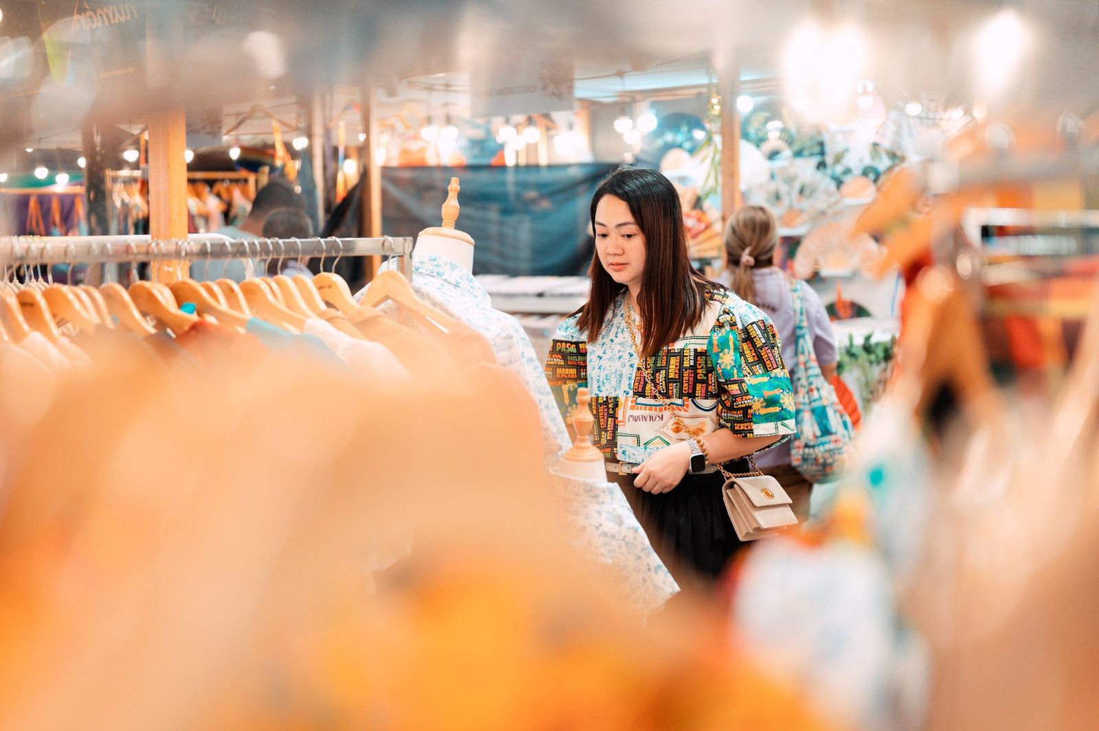 A shopper among the racks at our Negros Trade Fair 2025 booth