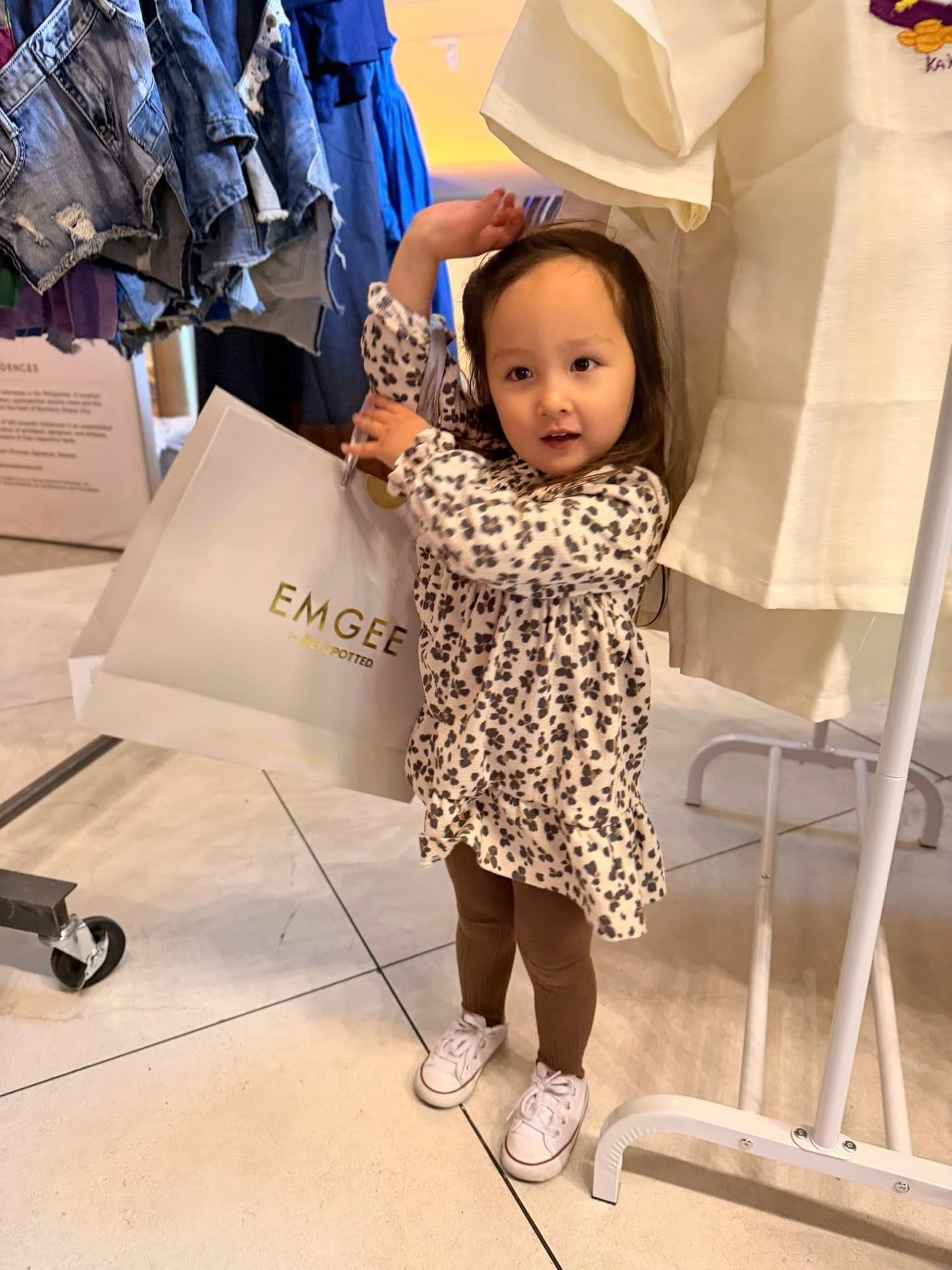 A young visitor with an EMGEE shopping bag at YAMAN New York